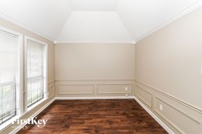 Bartlett house for rent - A room with wooden floors and white walls.