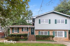 Conyers house for rent - A two-story house with a green door and shutters.