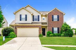 Greenwood house for rent - a large brick house with a white garage door