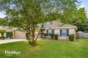 Jacksonville house for rent - a home with blue shutters and a tree in the front yard