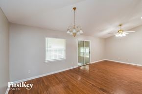 Jacksonville house for rent - a living room with a wood floor and a chandelier