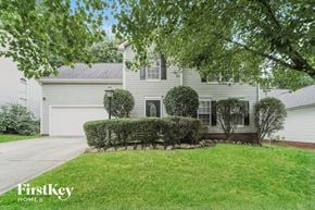 Charlotte house for rent - a white house with a lawn and a driveway