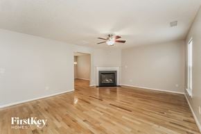 Charlotte house for rent - a living room with a fireplace and wooden floors