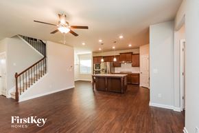 Mcdonough house for rent - an open kitchen and living room with a ceiling fan