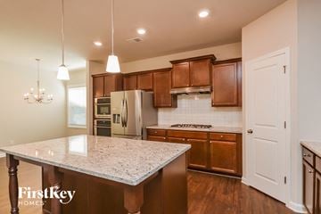 Mcdonough house for rent - an updated kitchen with granite countertops and wooden cabinets