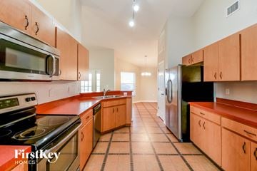 Lakeland house for rent - full view of kitchen with stainless steel appliances and orange counter tops