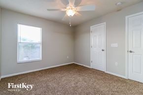 Lakeland house for rent - a bedroom with a ceiling fan and a white door