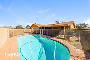 Phoenix house for rent - a swimming pool in front of a house with a fence
