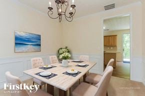 Kennesaw house for rent - A dining room with a wooden table set for six.