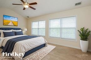 Kennesaw house for rent - A bedroom with a bed, a ceiling fan, and a painting on the wall.