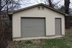 Memphis house for rent - a white garage with a gray garage door on the side of it