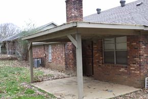 Memphis house for rent - the front of a brick house with a porch