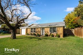 Plano house for rent - A house with a tree in front of it.