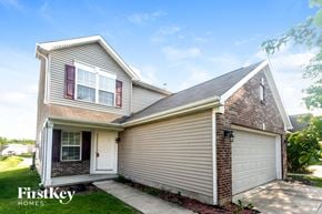 Indianapolis house for rent - A house with a garage and a brick chimney is for sale.