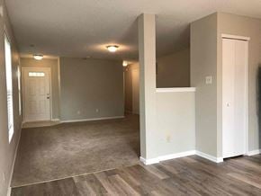Indianapolis house for rent - a living room with white walls and wood floors