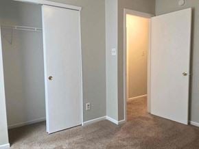 Indianapolis house for rent - a bedroom with a closet and a door open to a hallway