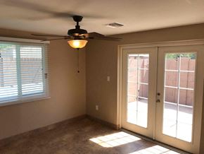 Phoenix house for rent - a living room with a ceiling fan and a door to a patio