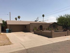 Phoenix house for rent - the front of our house with a driveway and a parking lot