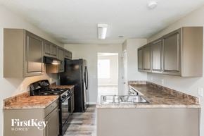 Powder Springs house for rent - a kitchen with stainless steel appliances and granite counter tops