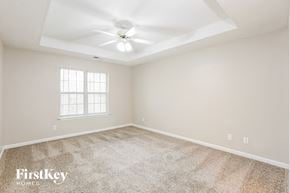 Powder Springs house for rent - a bedroom with carpet and a ceiling fan