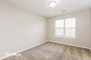 Powder Springs house for rent - a spacious room with carpet and a window