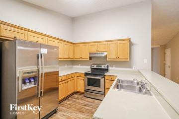 Gainesville house for rent - a kitchen with stainless steel appliances and wooden cabinets