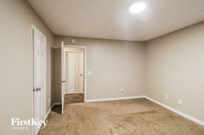 Gainesville house for rent - a bedroom with a door and a carpeted floor