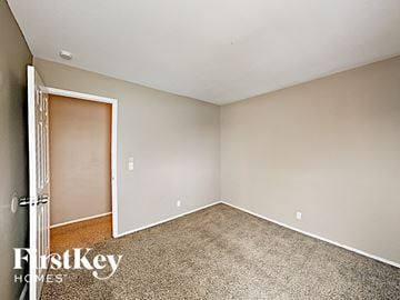 Florissant house for rent - a bedroom with carpet and a door to a closet