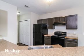 North Port house for rent - a kitchen with black appliances and a black refrigerator