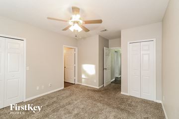 North Port house for rent - a spacious living room with carpet and a ceiling fan