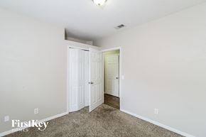 North Port house for rent - a bedroom with two closets and a door to a hallway
