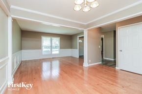 Florissant house for rent - an empty living room with wood floors and white walls