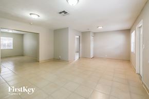 Lauderdale Lakes house for rent - a spacious living room with beige tile floors and white walls