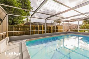 Lauderdale Lakes house for rent - a swimming pool in a house with a glass walled pool