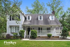 Charlotte house for rent - a white house with a gray roof and a white porch