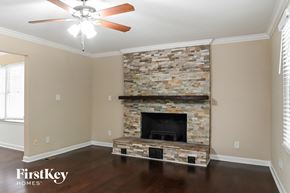 Charlotte house for rent - the living room has a stone fireplace and hardwood floors