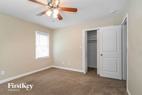 Charlotte house for rent - a bedroom with a ceiling fan and a closet