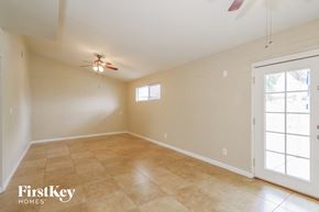 Phoenix house for rent - the living room is spacious and clean with a ceiling fan
