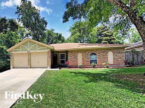 Spring house for rent - a small brick house with a yard and a garage