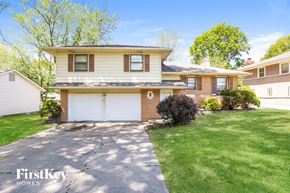 Independence house for rent - a home with a white garage door and a lawn