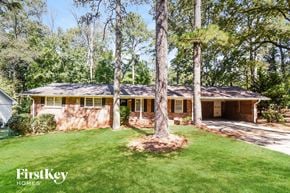 College Park house for rent - a house with a lawn and trees in front of it