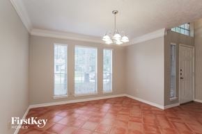 Humble house for rent - a formal dining room with windows and a door to a patio