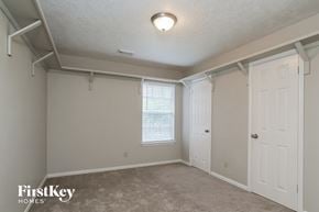 Humble house for rent - a bedroom with a closet and a white door and a window