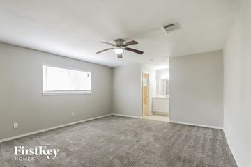 Spring house for rent - a living room with a ceiling fan and a carpet