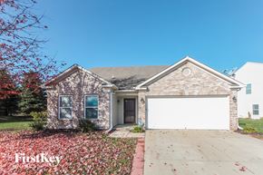 Indianapolis house for rent - a brick house with a white garage door