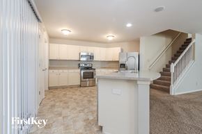 Indianapolis house for rent - a kitchen with white cabinets and a counter top