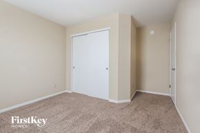 Indianapolis house for rent - a bedroom with a closet and a carpeted floor