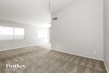 Glendale house for rent - the living room and dining room with white walls and carpet