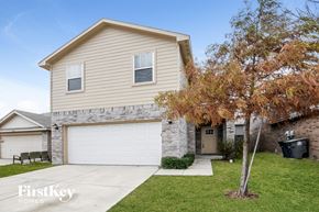 Dallas house for rent - a tan house with a white garage door