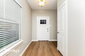 Dallas house for rent - the entryway of a home with a white door and window